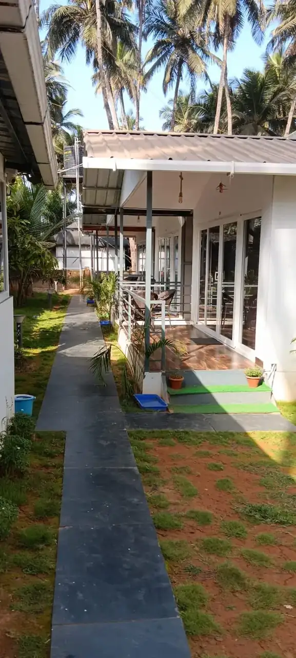 Garden path connecting guest rooms at Saffron Sun Palolem