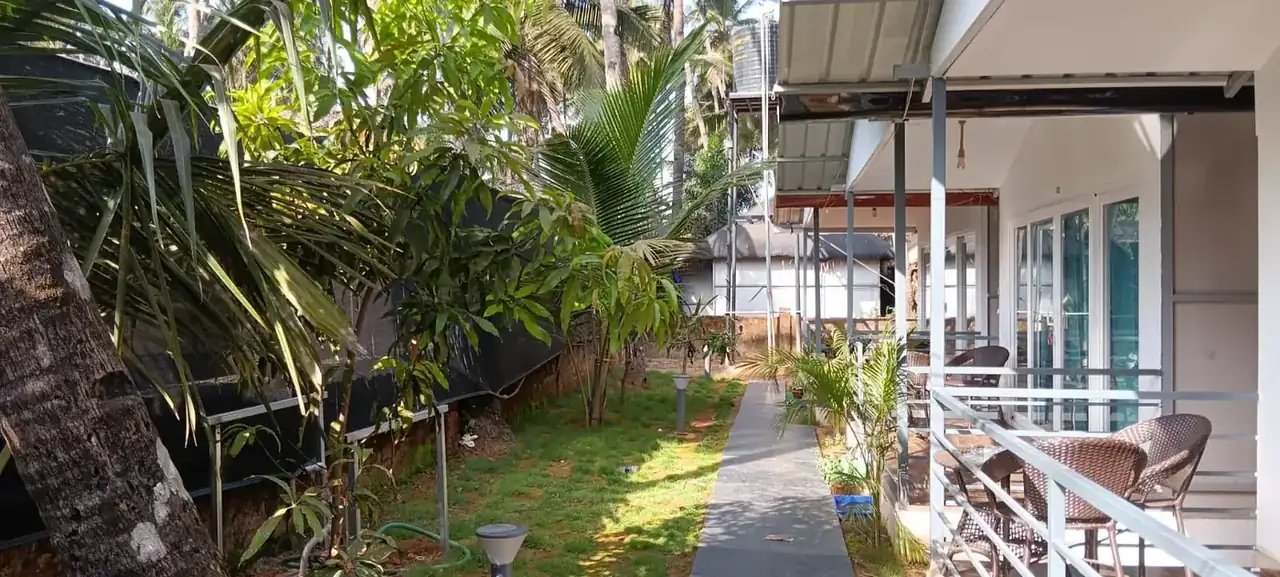 Tropical garden and veranda beside the rooms at Saffron Sun Palolem