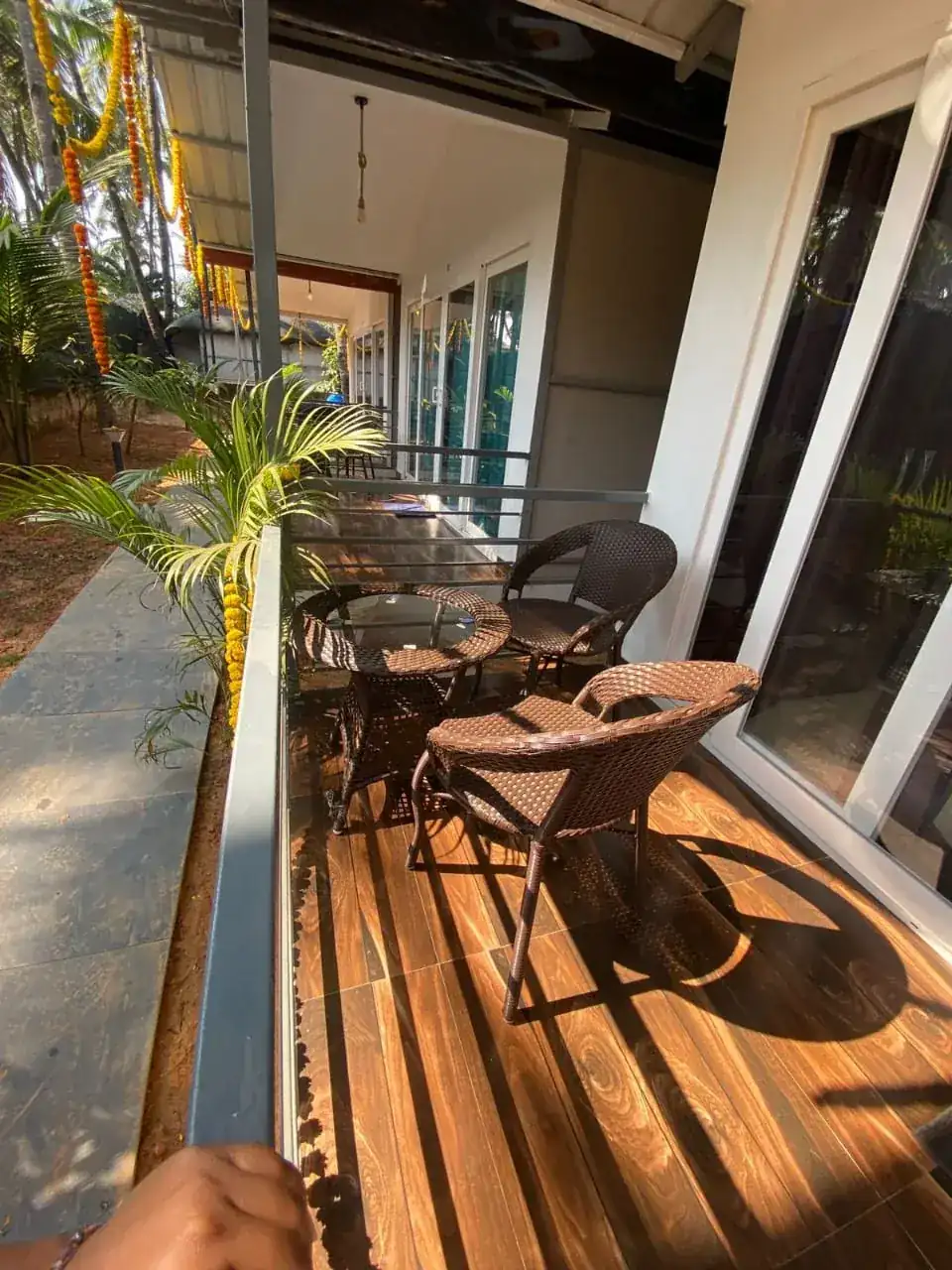 Veranda seating at Saffron Sun Palolem overlooking a tropical garden