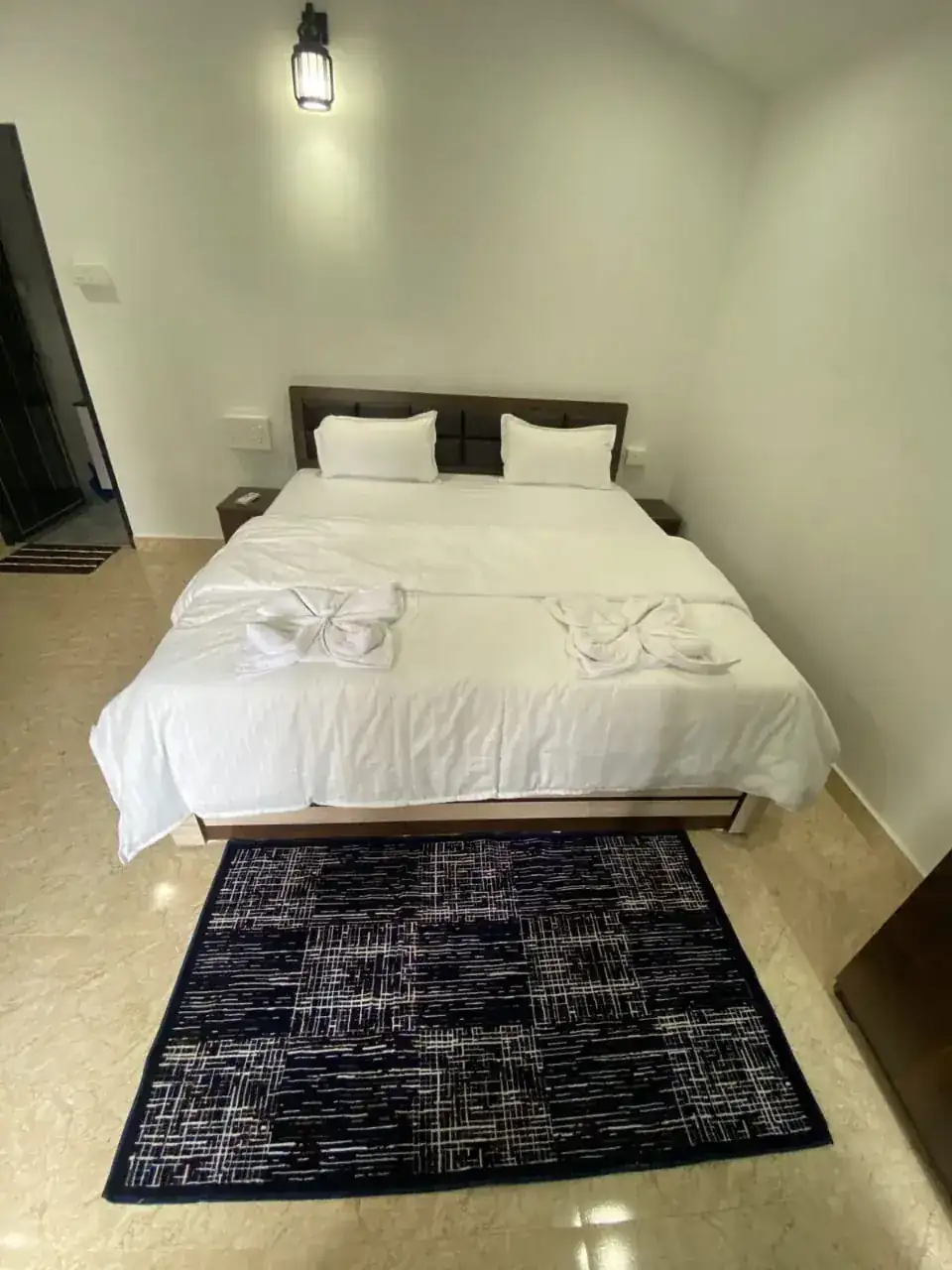 Bright bedroom interior at Saffron Sun Palolem with neatly arranged double bed
